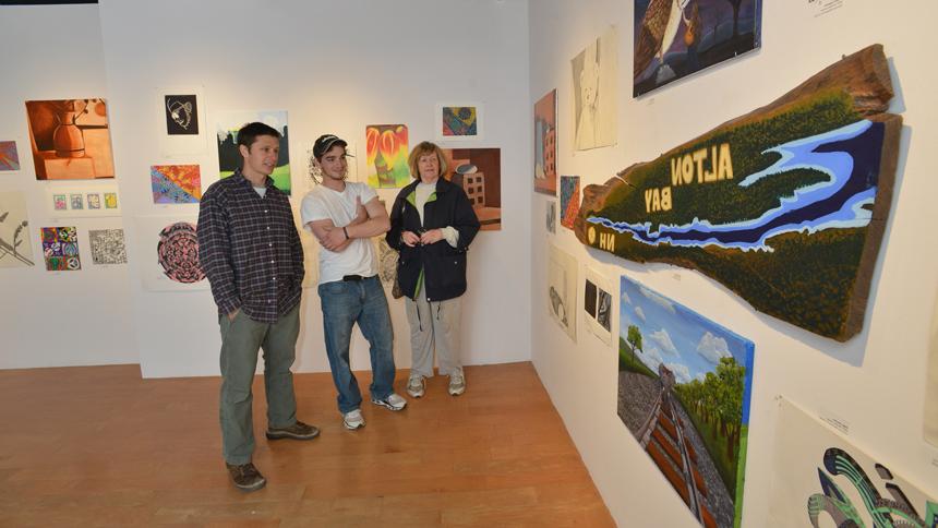 students admiring student art work