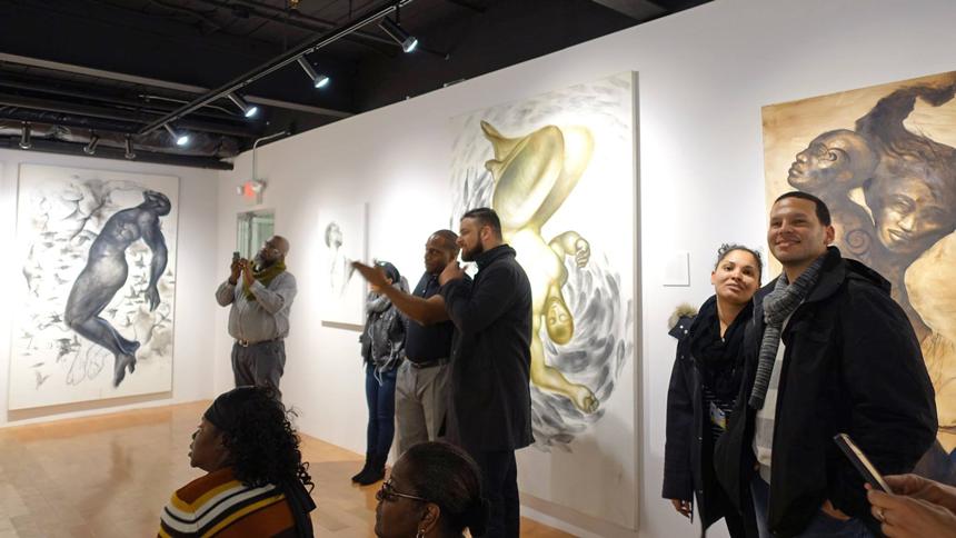 art aficionados enjoying Art and Soul exhibit